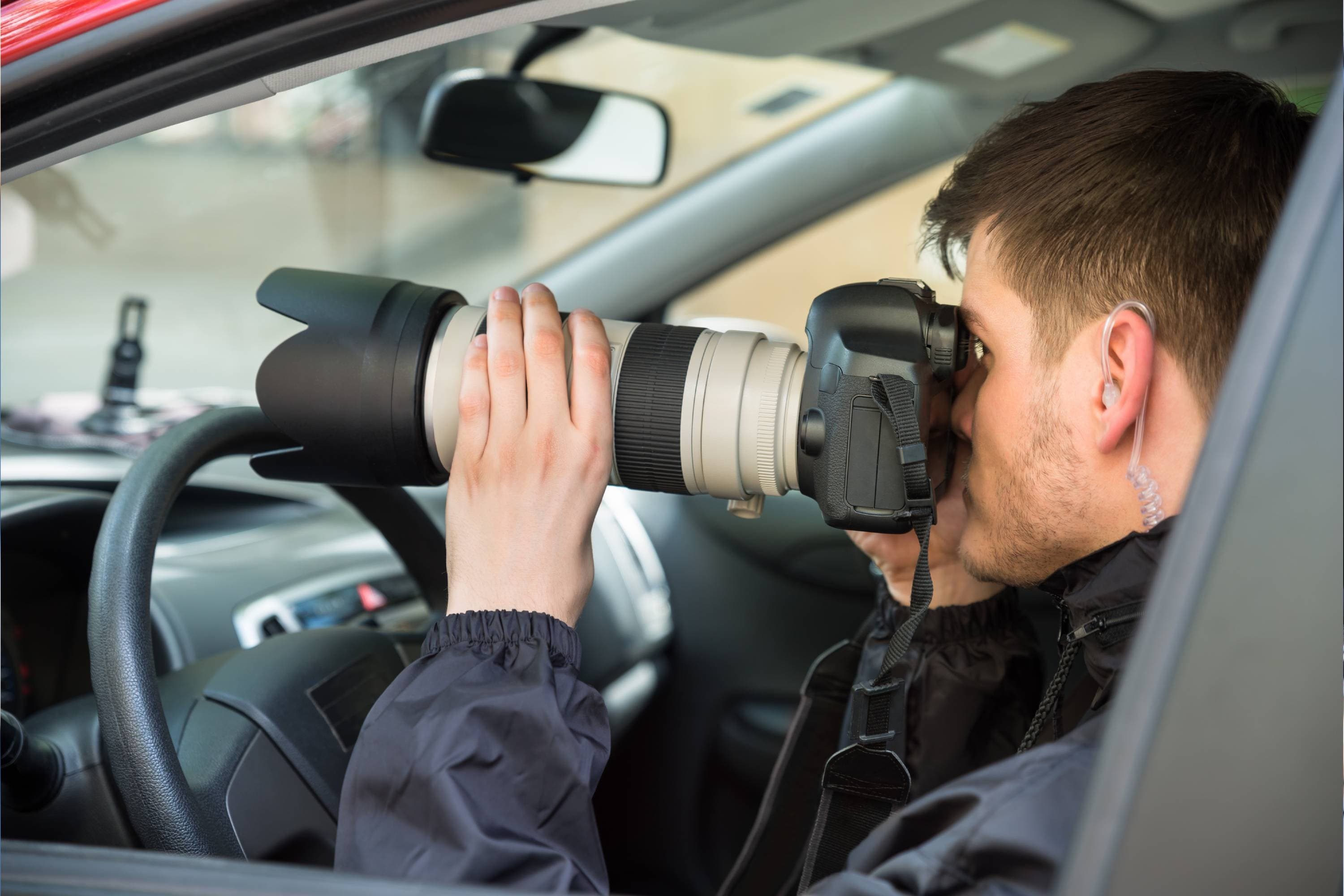 Close-up Of A Young Man Inside Car Photographing